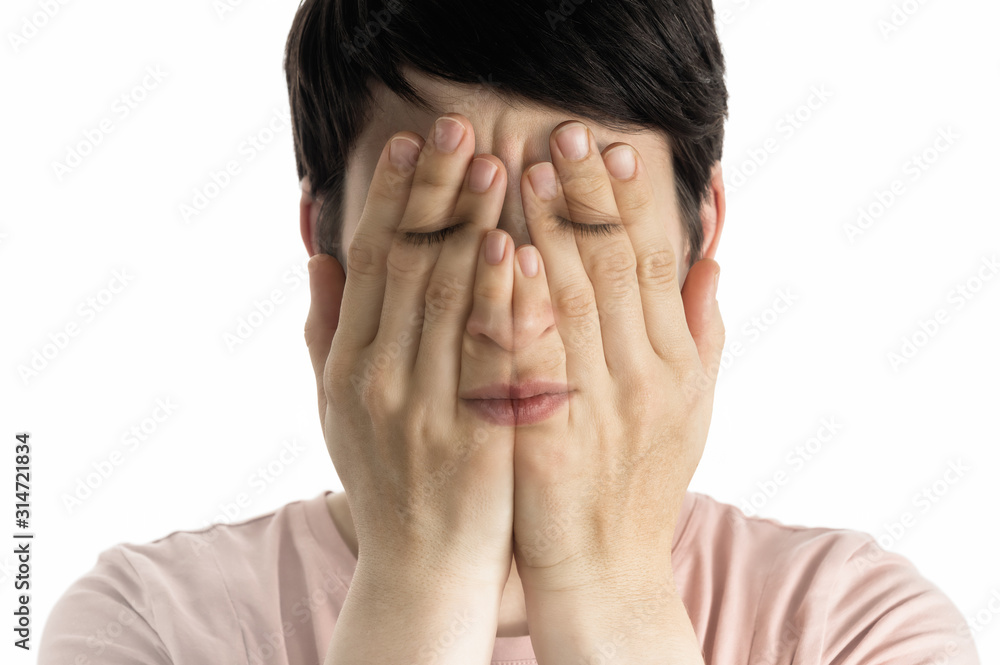 Concept of fear, shame, domestic violence. Woman covers her face her hands on white background. Concept of fear, shame, domestic violence. Woman covers her face her hands on white background.