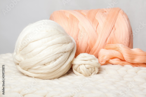 a ball of thick yarn and a blanket of thick wool