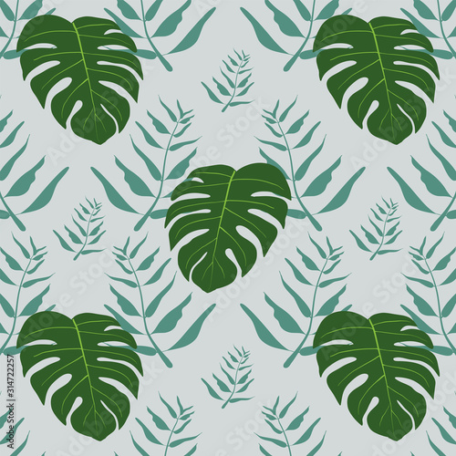 Tropical diamond array seamless  pattern of leaves on green background.