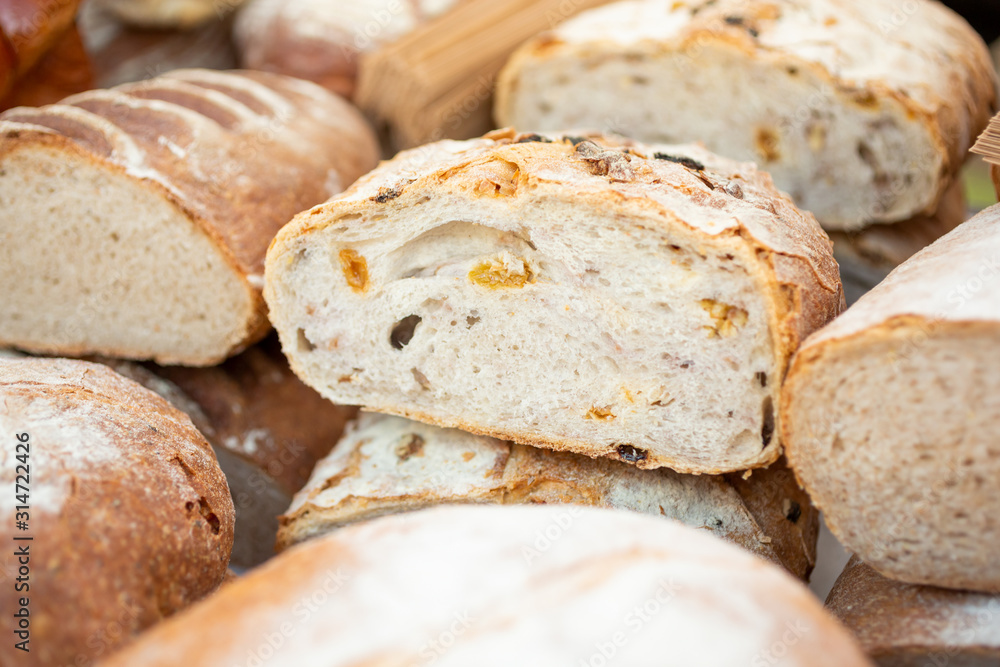 A view of several cut loaves of fresh artisan bread on display at a local bakery. A view of several cut loaves of fresh artisan bread on display at a local bakery.