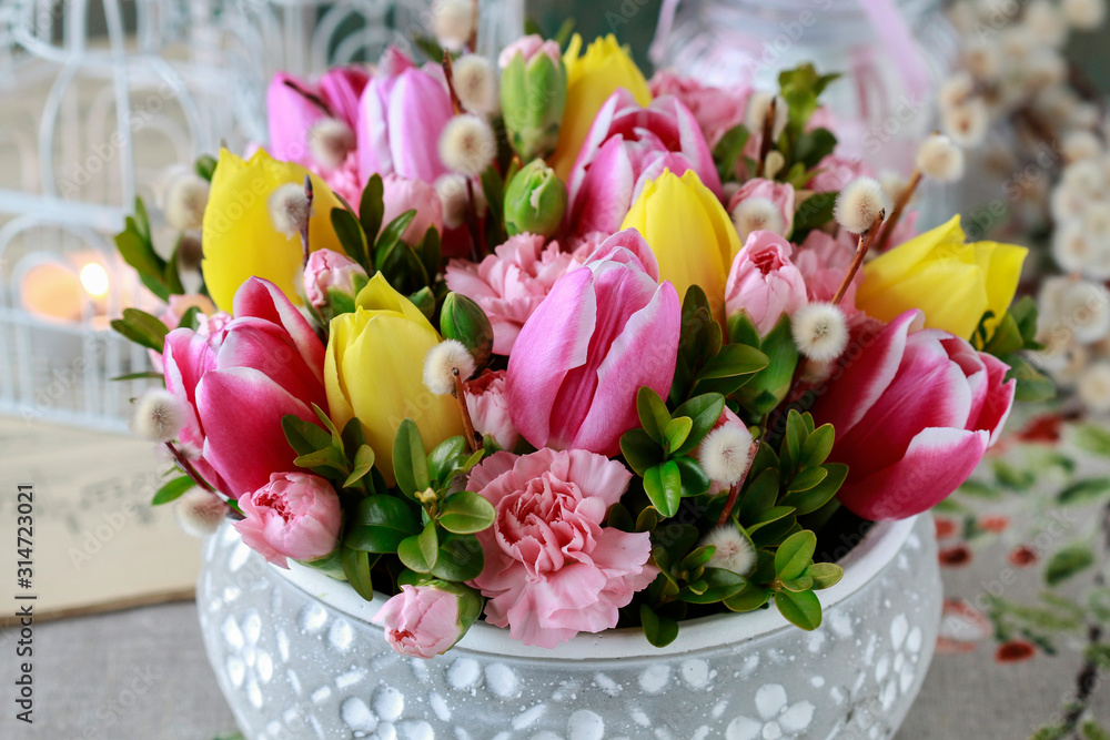 Woman shows how to make beautiful floral arrangement with tulip and carnation flowers