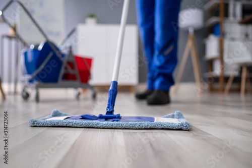 Photography Happy Male Janitor Mopping Floor In Office