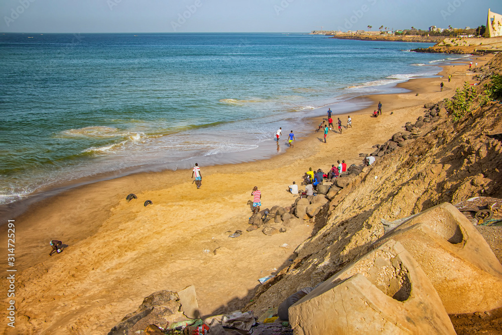 Dakar, Senegal- April 24 2019: Men playing football on the beach near Dakar city in Africa. It is the capital city of Senegal.