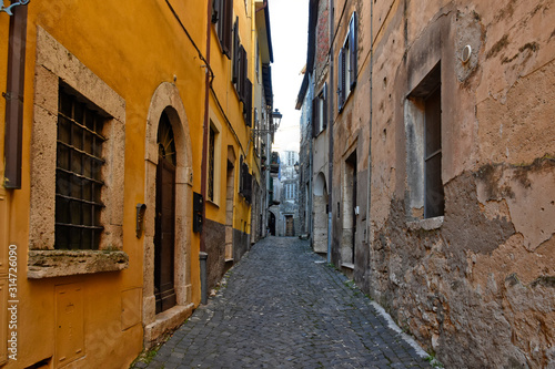 Alatri, Italy, 01/03/2020. A narrow street between the old houses of a medieval village © Giambattista