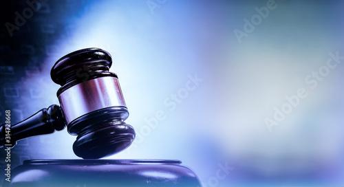 Valokuva Law concept image, gavel set against bright computer monitor screen background