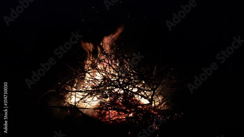Burning fire. Bonfire. Closeup of flames burning on black background. Burning red hot sparks rise from large fire in the night sky. Bonfire burning trees at night. 