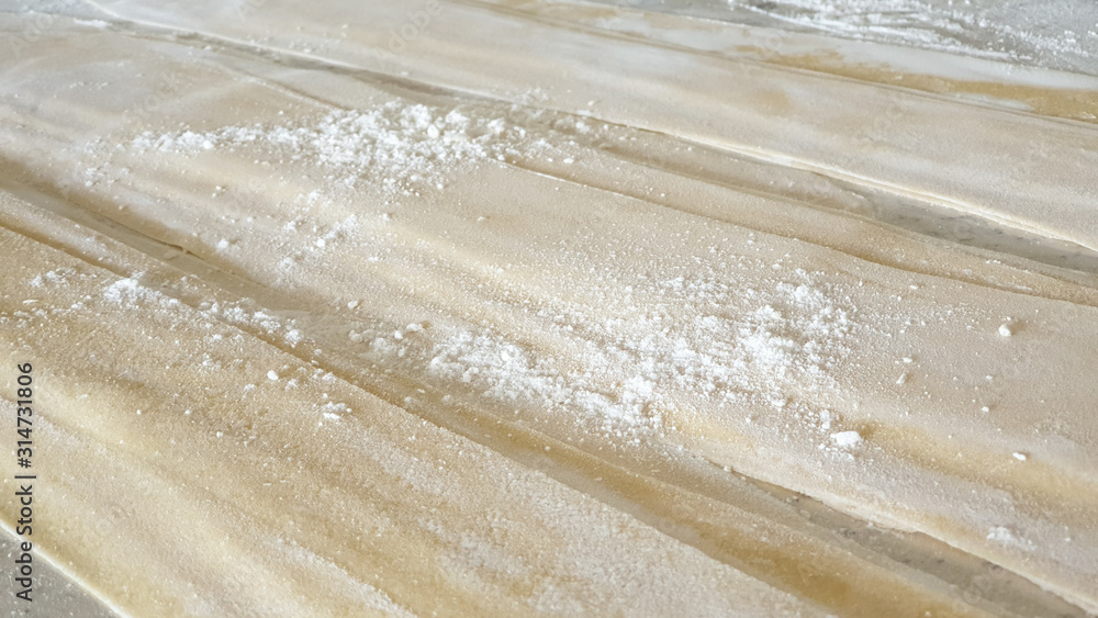 Fresh home made raw pasta sheet on chef table Fresh home made raw pasta sheet on chef table