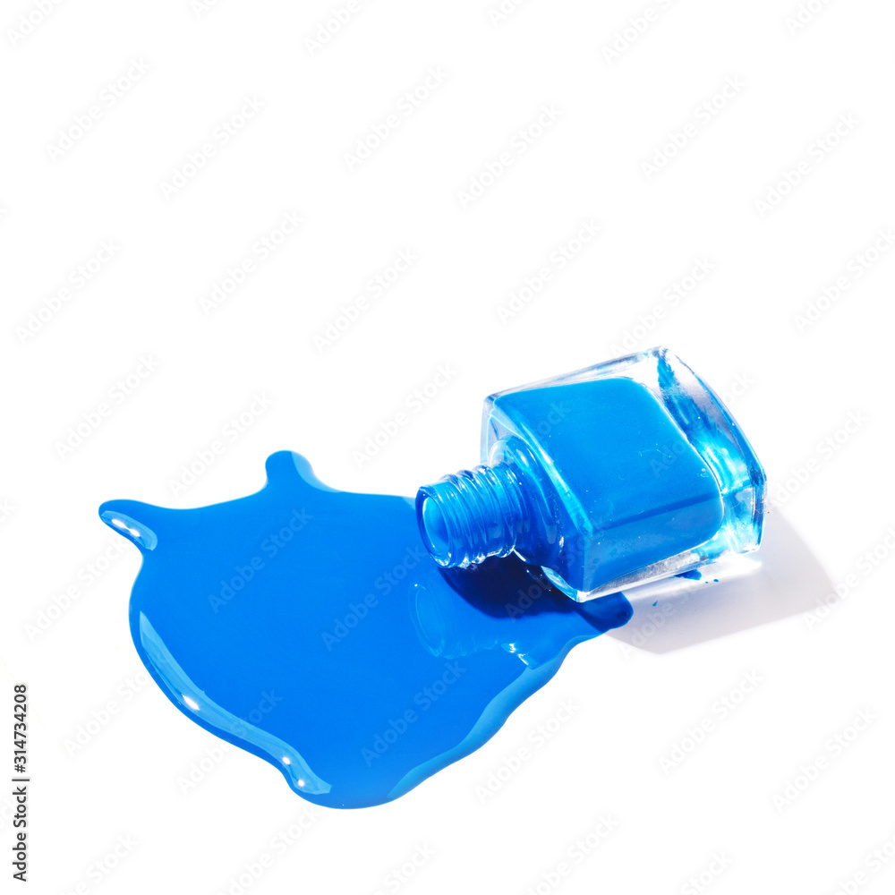 Colored nail polish is spilled on a white background Colored nail polish is spilled on a white background
