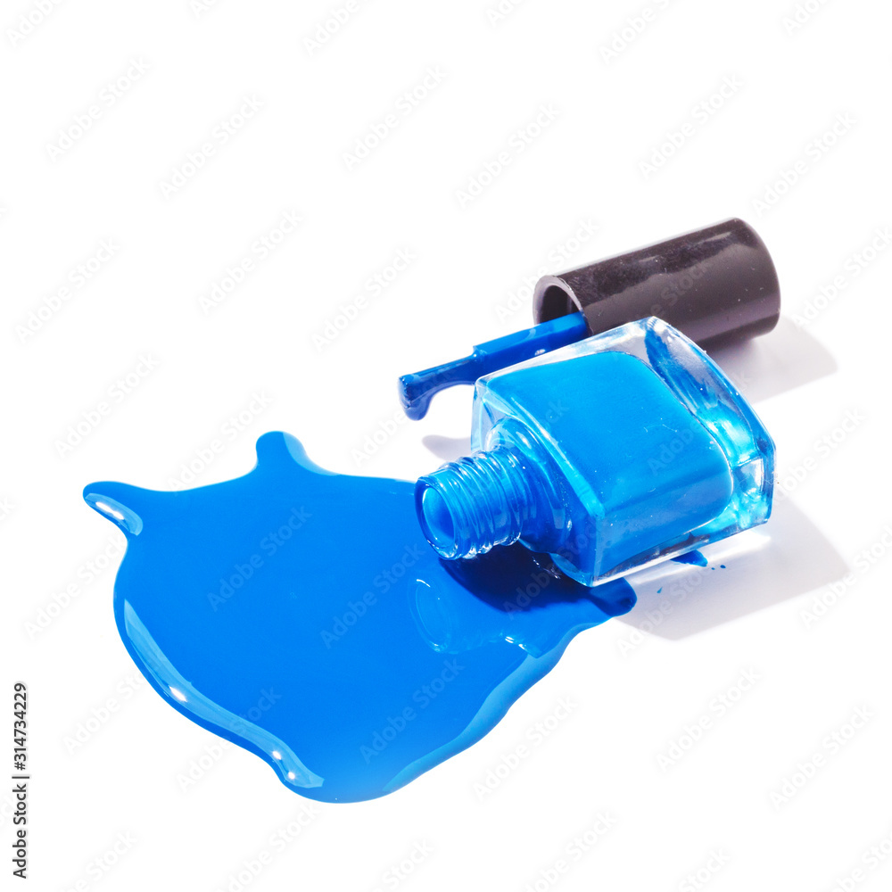 Colored nail polish is spilled on a white background Colored nail polish is spilled on a white background