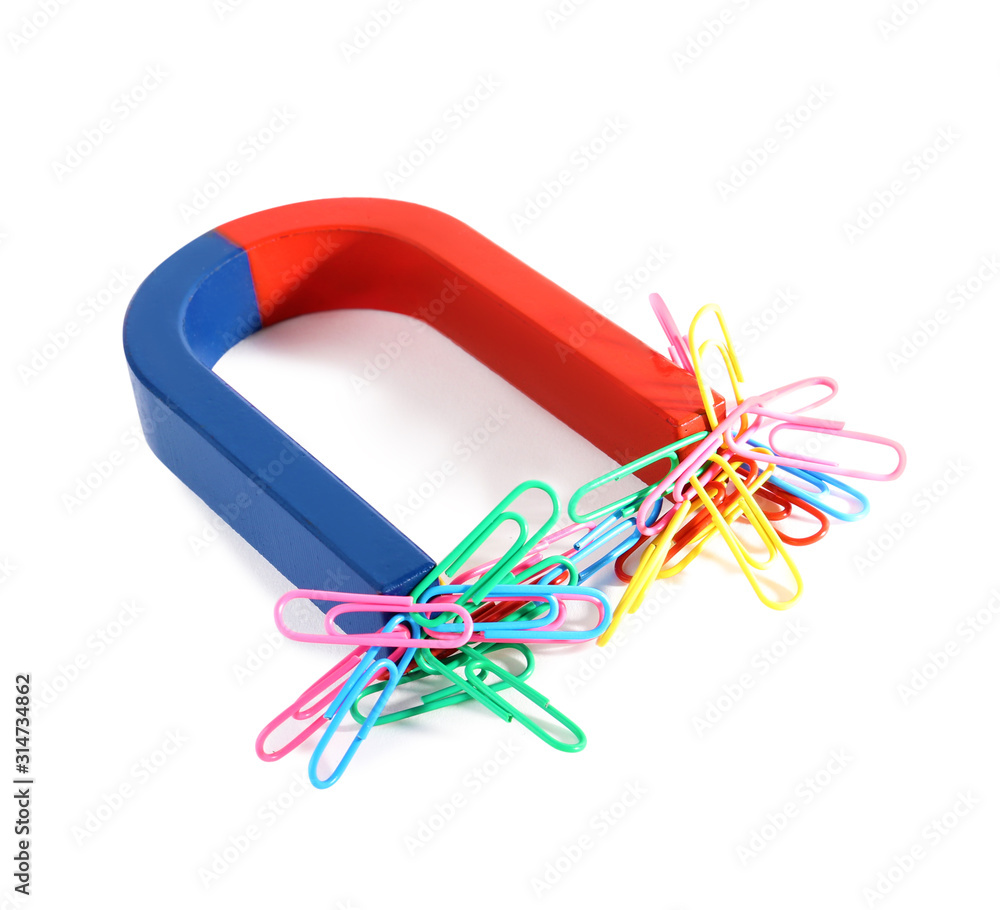 Magnet attracting paper clips on white background Magnet attracting paper clips on white background