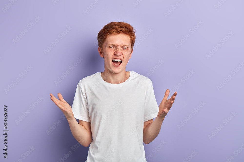Portrait of a handsome young man in white shirt shouting with two arms open, smiling and happy expression, isolated on blue background. Portrait of a handsome young man in white shirt shouting with two arms open, smiling and happy expression, isolated on blue background.