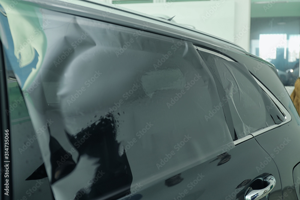 Car window covered with tinting foil, closeup Car window covered with tinting foil, closeup