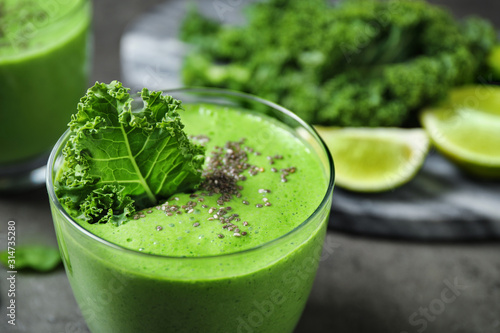 Tasty kale smoothie with chia seeds on grey table, closeup