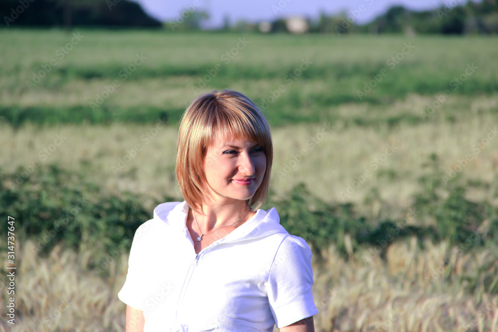 Girl in a white jacket on the background of the field Girl in a white jacket on the background of the field