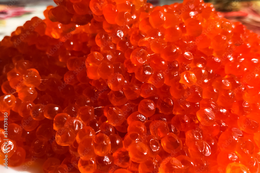 Red caviar on plate on the table. Salmon caviar. Dietary nutriti Red caviar on plate on the table. Salmon caviar. Dietary nutriti