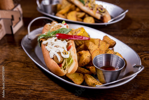 Hotdogs and French fries on a dishes. Fast food meal. Restaurant.