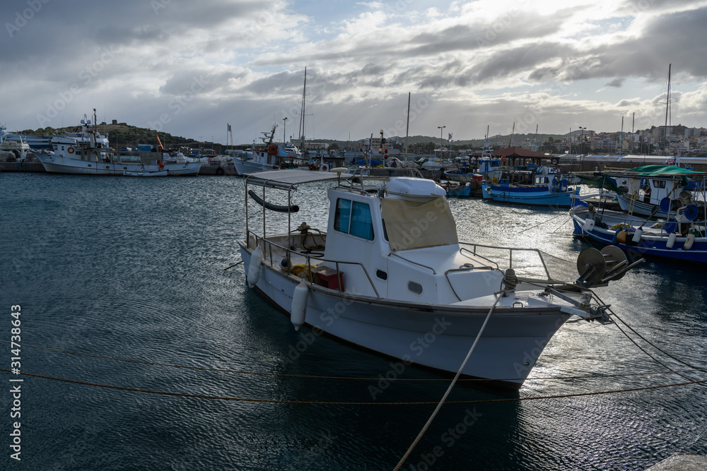 Fototapeta premium Small fishing boat moored in the port