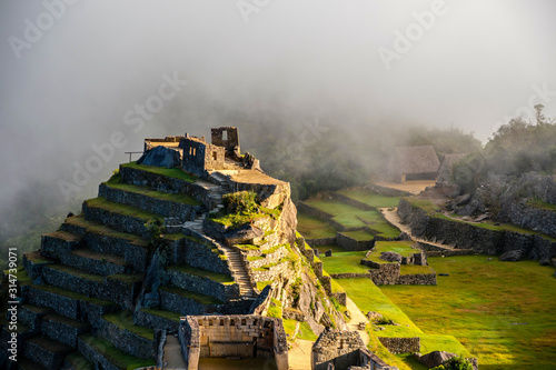 Intihuatana pyramid in a mist with ritual stone on Machu Picchu archeological site, Cusco, Peru, South America