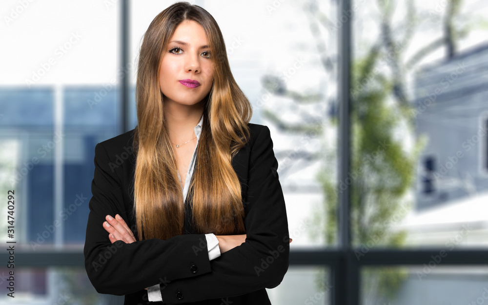 Smiling businesswoman portrait in a modern office Smiling businesswoman portrait in a modern office