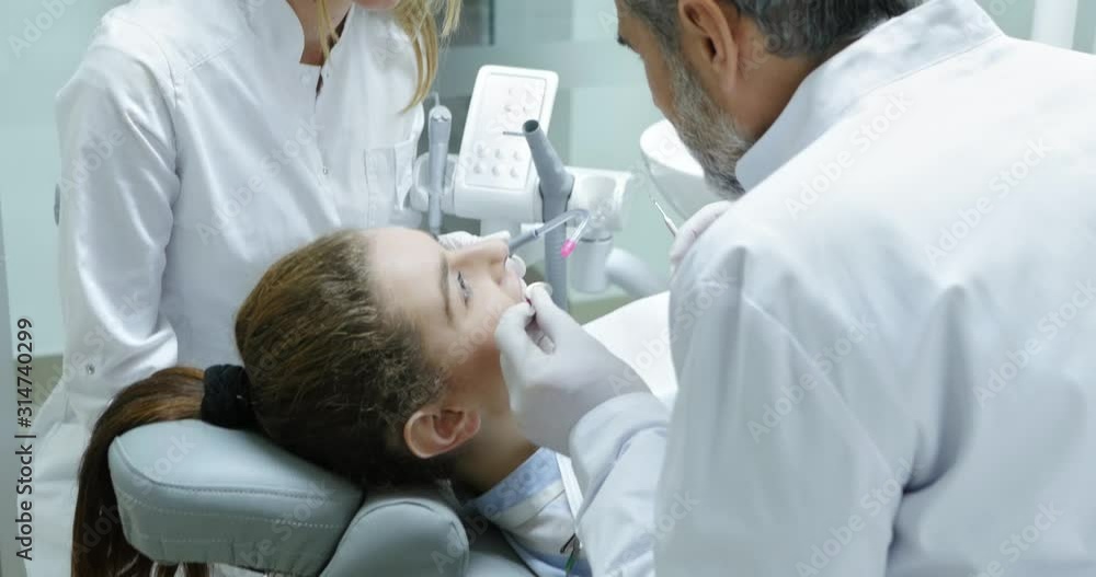 Dentist doing teeth examination. Dentist doing teeth examination.