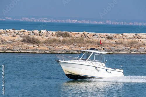  White power boat on blue sea. © Shmel