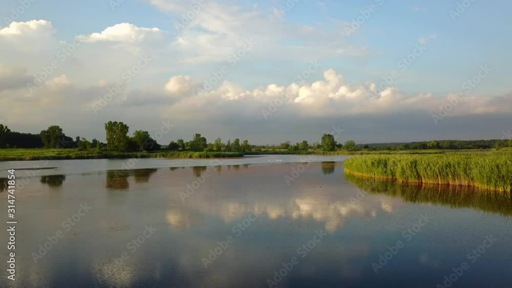 Low Flying Aerial Shot Over Reflective Lake in Ontario