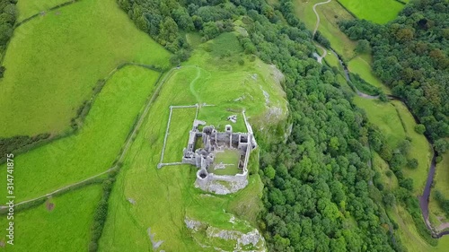 Drone Aerial shot of Carreg Cennen Castle Wales tilt up reveal photo