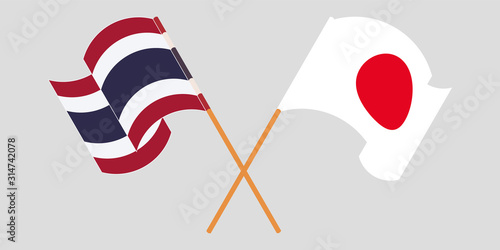 Crossed and waving flags of Thailand and Japan