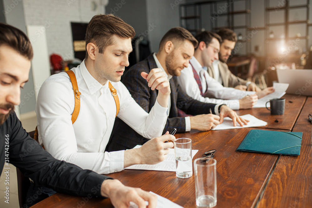 successful, confident business co-workers sit in office and have brainstorming time, thinking about development of their company, how to solve problems connected with finance successful, confident business co-workers sit in office and have brainstorming time, thinking about development of their company, how to solve problems connected with finance