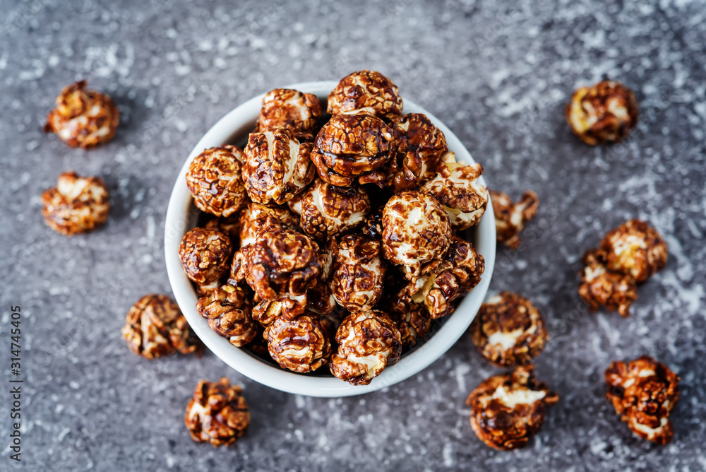 Chocolate caramel sweet Popcorn in a white bowl Chocolate caramel sweet Popcorn in a white bowl