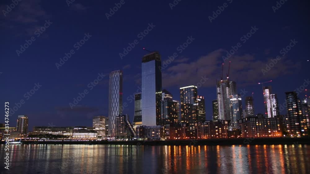 Canary Warf 4K Time-lapse showing the setting of the dark.Boats on the river. Canary Warf 4K Time-lapse showing the setting of the dark.Boats on the river.