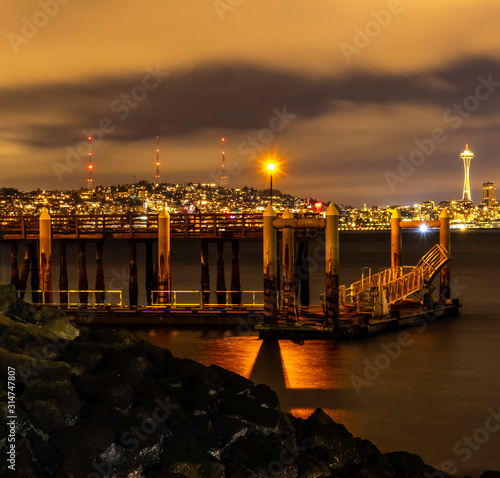 Seattle Night city skyline from Alki Beach with Dock in Foreground