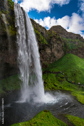 Iceland - Tourists Taking the Wet Trip Under the Falls © Agent007