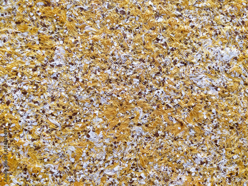 Liquid wallpaper with embossed pattern texture. Yellow cellulose wallpaper with decorative elements. A popular type of coating for walls and ceilings. Liquid wallpaper with embossed pattern texture. Yellow cellulose wallpaper with decorative elements. A popular type of coating for walls and ceilings.