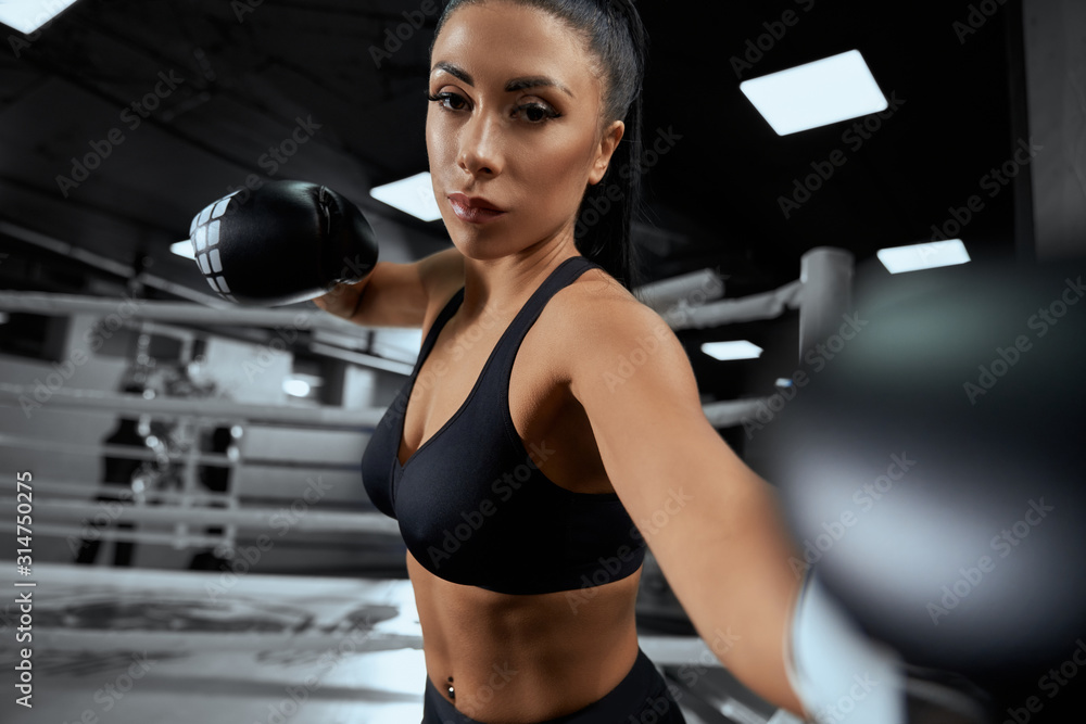 Fototapeta premium Woman fighting in boxing gloves.