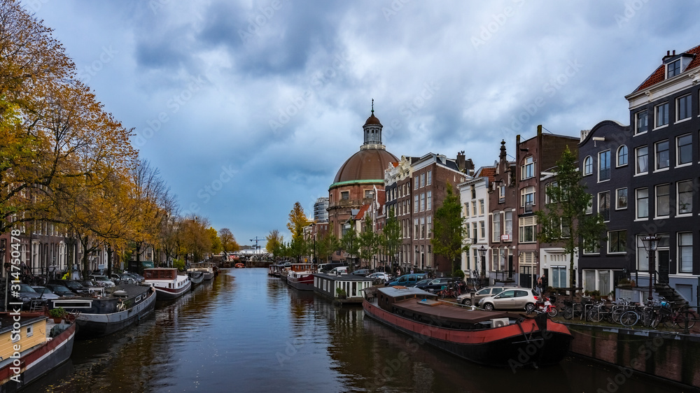 Netherlands - Many Boats in Canal by Cathedral