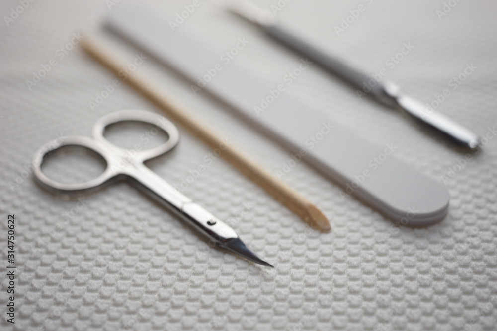 Set of tools for manicure on the table, scissors, nail file, orange stick, cuticle shovel. Set of tools for manicure on the table, scissors, nail file, orange stick, cuticle shovel.