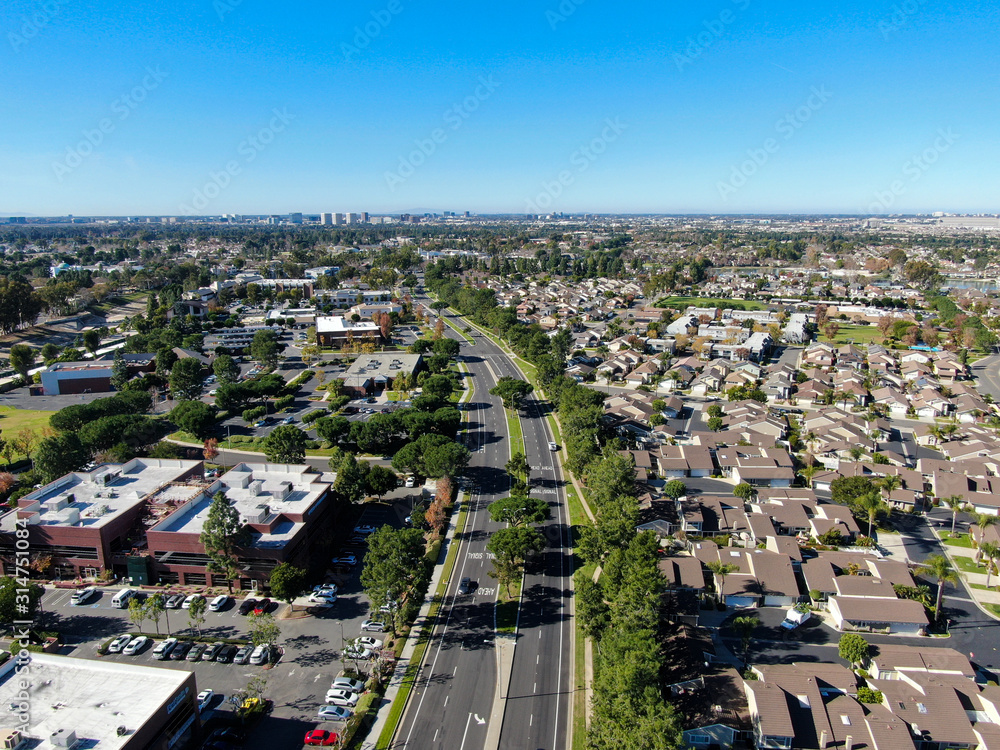 Aerial view of residential suburban packed homes neighborhood during blue sky day in Irvine, Orange County, USA