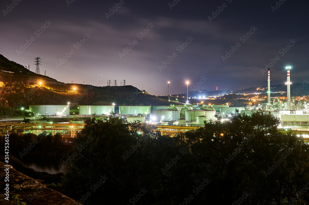 Main tower and chimneys of the Petronor refinery in the municipality Bizkaino of Muskiz, near beach of the Arena, photographed at night, Basque Country, Biscay, Euskadi, Euskal Herria, Spain, Europe