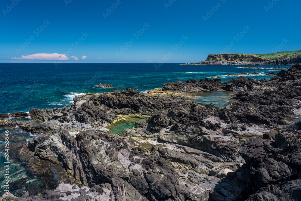 natural pool  in terceria, view of the rocky seaside in terceira with natural pool to have a bath, seascape in azores, portugal.