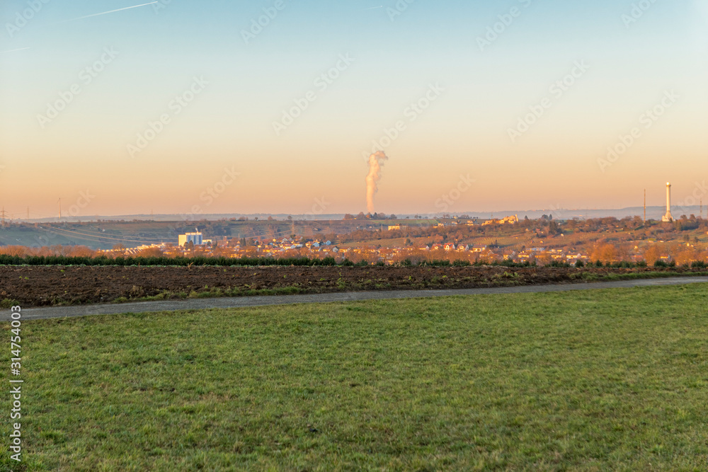 Landscape with nuclear power plant Column of smoke in the background at sunset