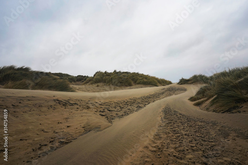 Sand dunes by the sea on a cloudy windy day, Camber Sands, UK 