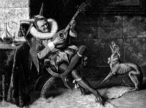 Jester in costume, cap and ruff entertaining himself and his dog playing mandolin sitting at a table with a glass of wine beside