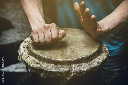 ethnic percussion musical instrument jembe and male hands