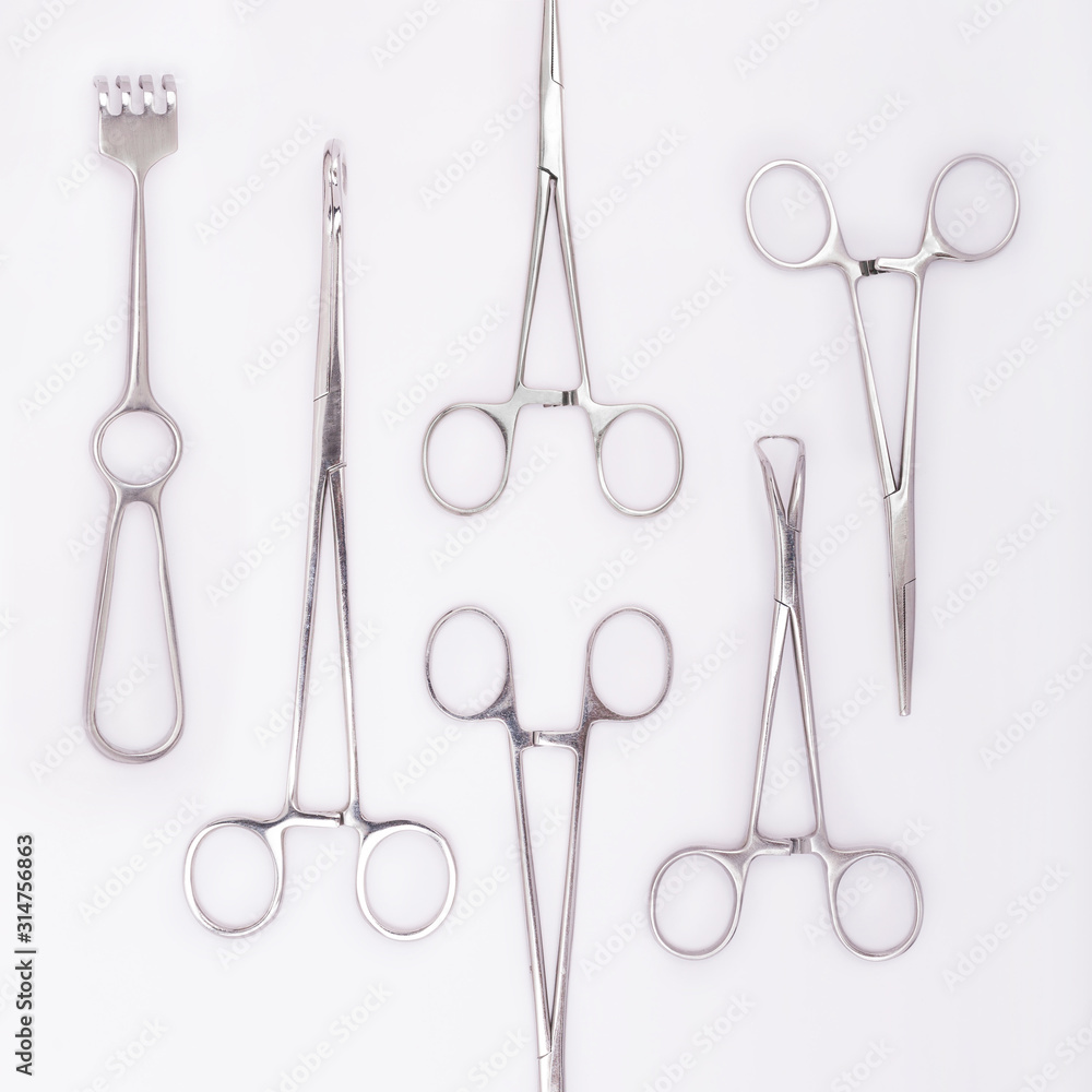 Close-up of stainless steel surgical instruments on white background