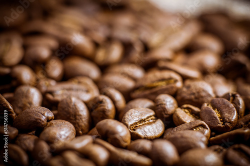 Premium quality light roasted coffee beans rotating. Close up of brown roasted coffee beans