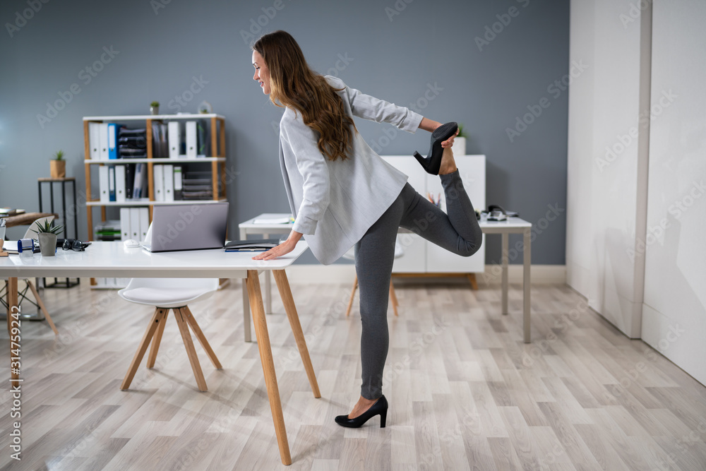 Businesswoman Stretching Her Leg In Office Businesswoman Stretching Her Leg In Office