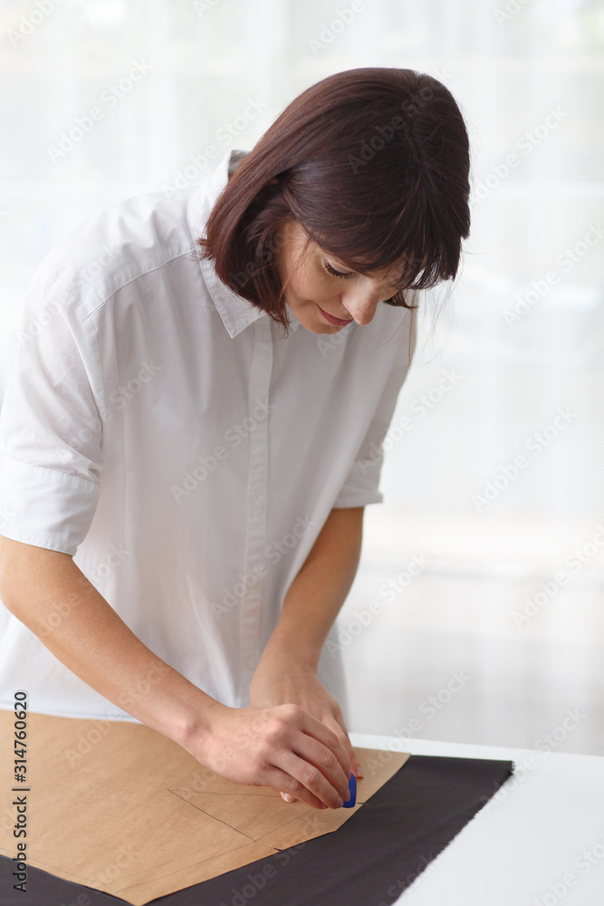 Close up portrait of fashion designer working in sewing studio. Close up portrait of fashion designer working in sewing studio.