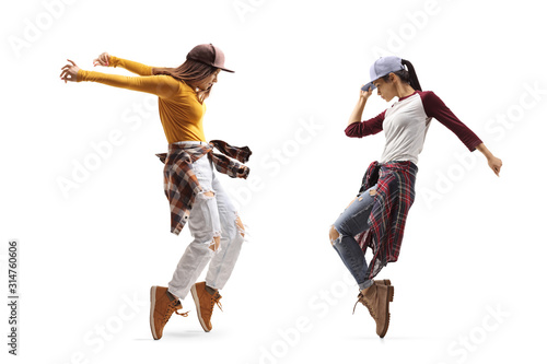 Fototapeta Naklejka Na Ścianę i Meble -  Two young females dancing street dance style