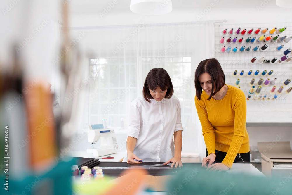 Close up portrait of fashion designer working in sewing studio. Close up portrait of fashion designer working in sewing studio.